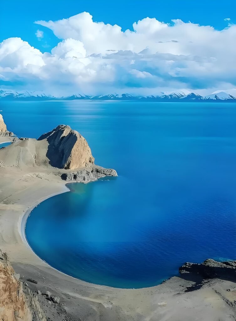 Namtso Lake, one of the most holy alpine lakes in Tibet, reflecting the snow-capped Nyenchen Tanglha mountain